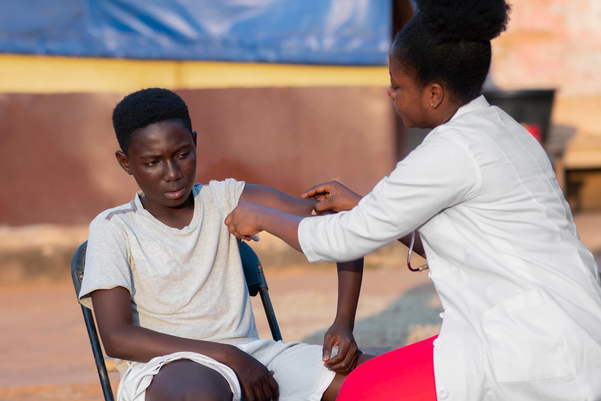 Child with cerebral palsy receiving injection from nurse